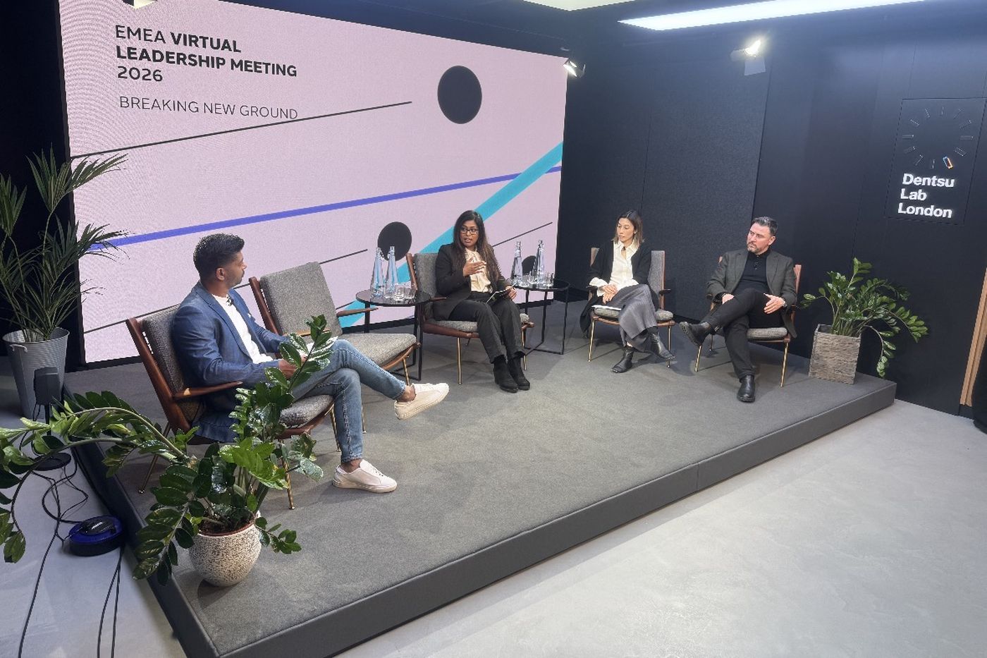 A four-person panel seated on a low stage at Dentsu Lab London, in front of a screen reading EMEA Virtual Leadership Meeting 2026, Breaking New Ground.